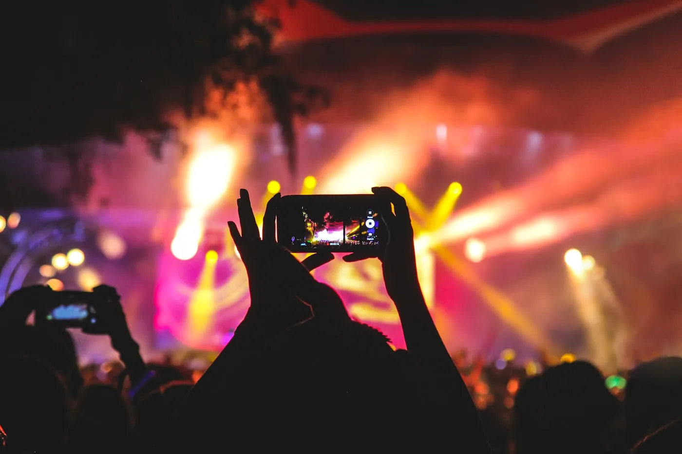 A performer on a brightly lit stage during a live show.
